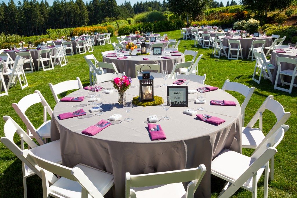 Tables, chairs, decor, and decorations at a wedding reception at an outdoor venue vineyard winery in oregon