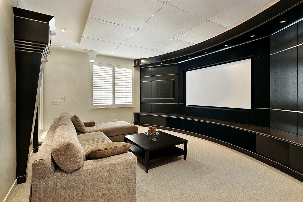 Theater room in luxury home with wide screen