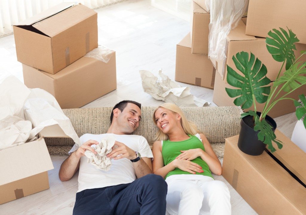 couple relaxing in the middle of cardboard boxes