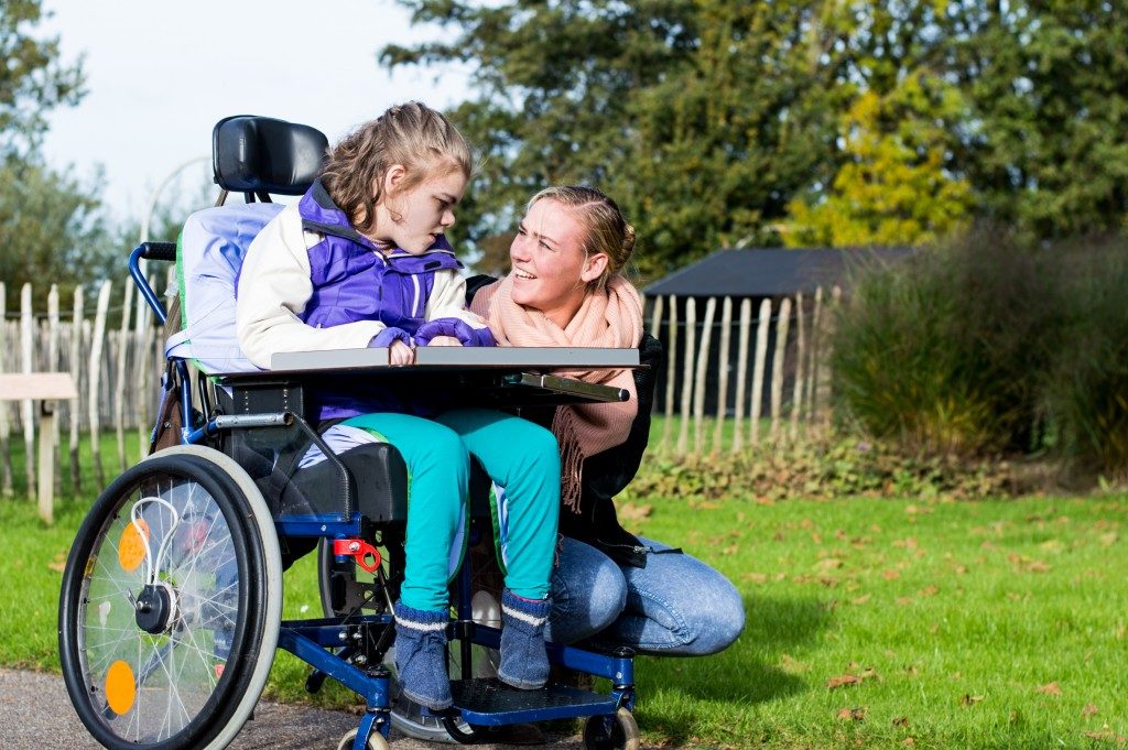 mother with her child in wheelchair