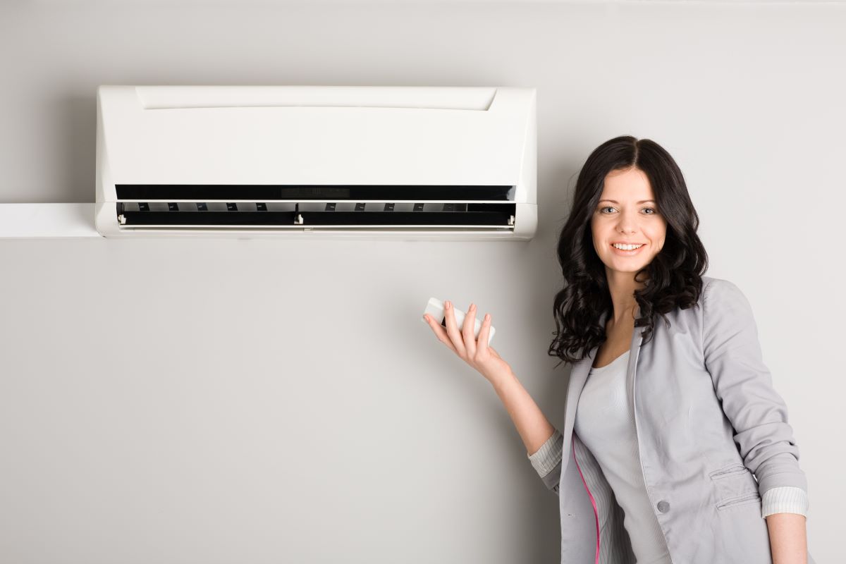 woman operating air conditioning unit