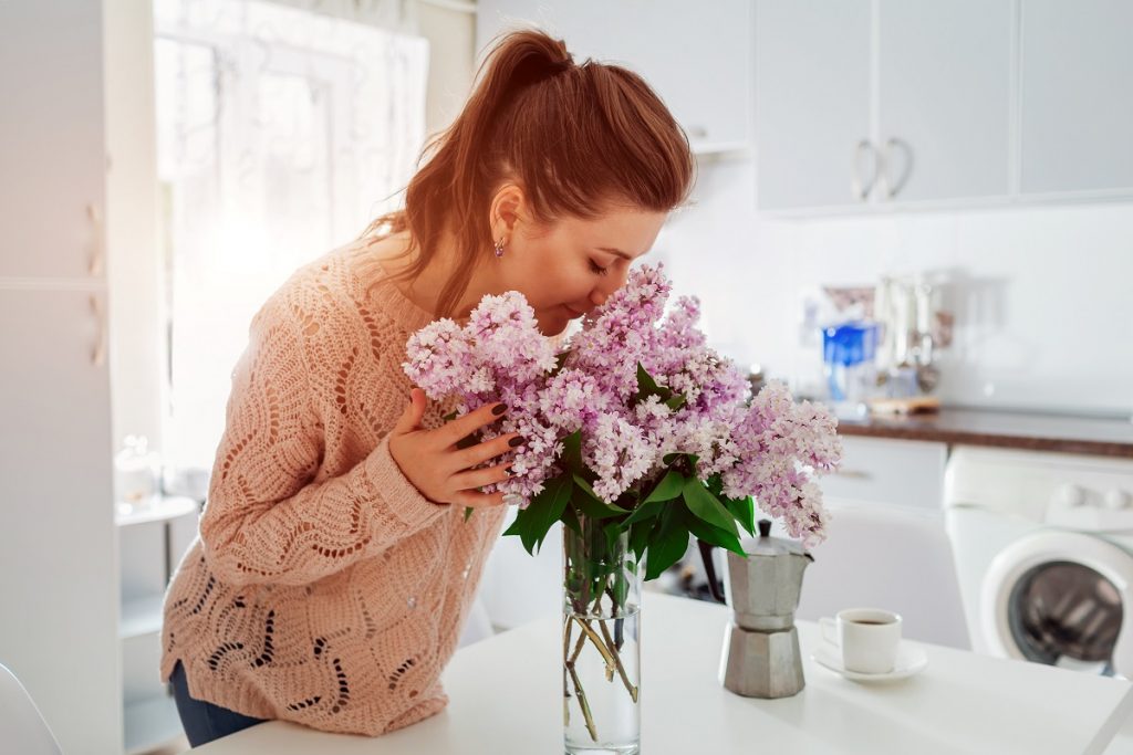 woman smelling flowers