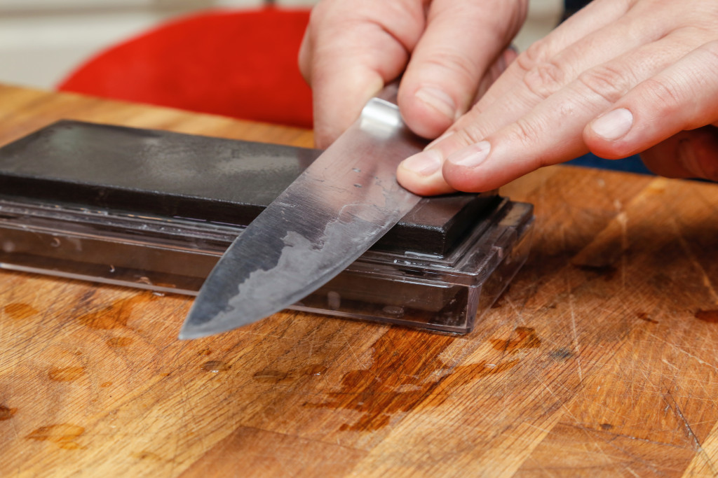 person sharpening a kitchen knife