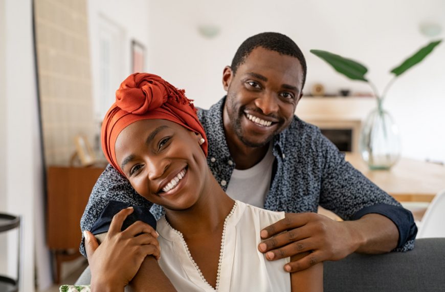 african american couple hugging at home