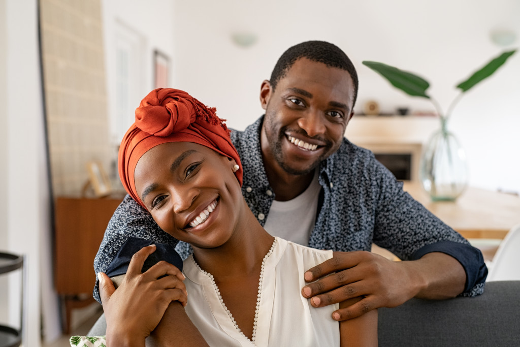 african american couple hugging at home