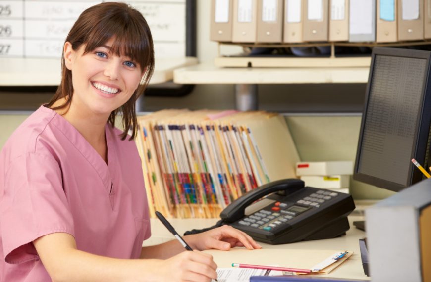 a woman in scrubs writing