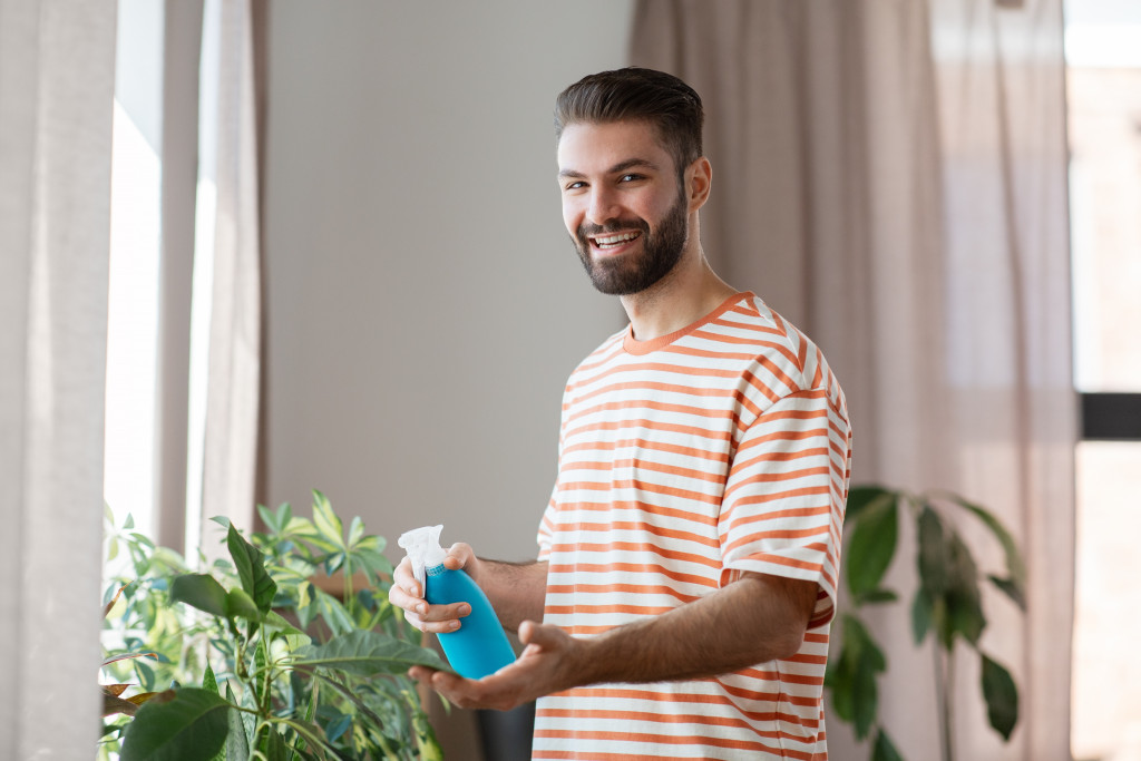 man watering home plants