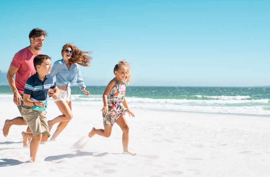 family running on the beach