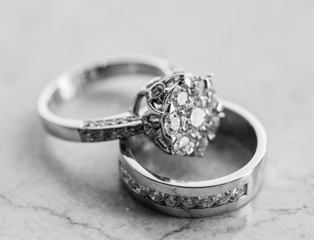Two diamond engagement rings on white marble
