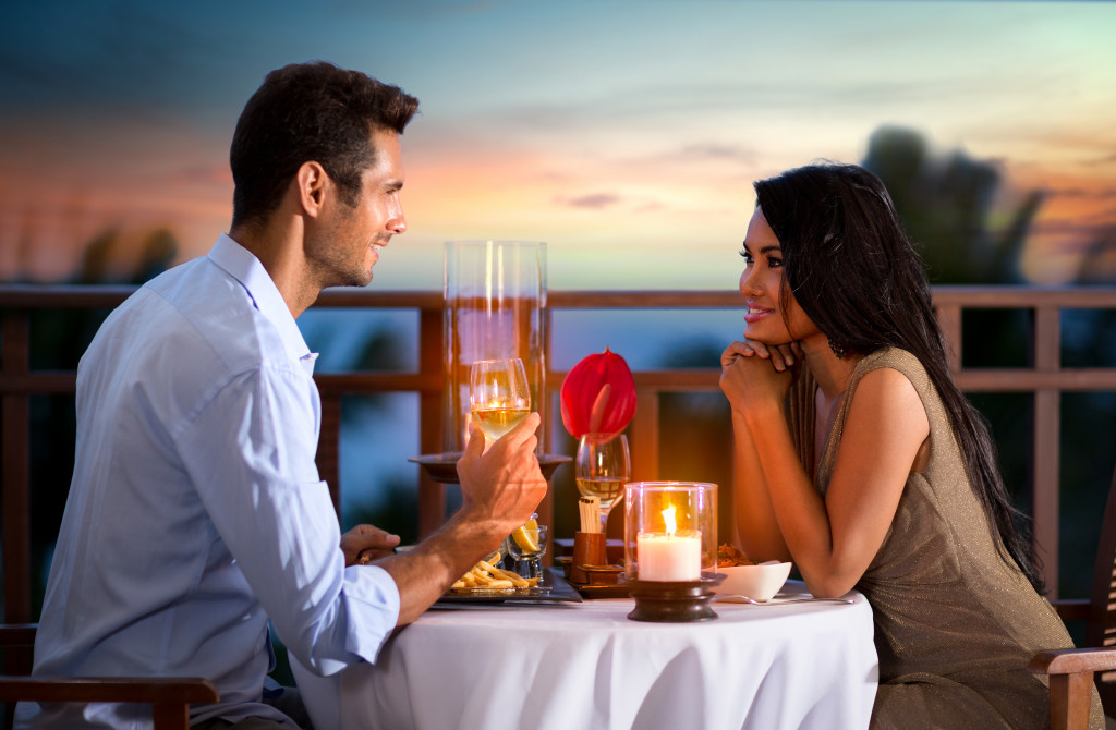 A couple looking at each other during a candlelit dinner