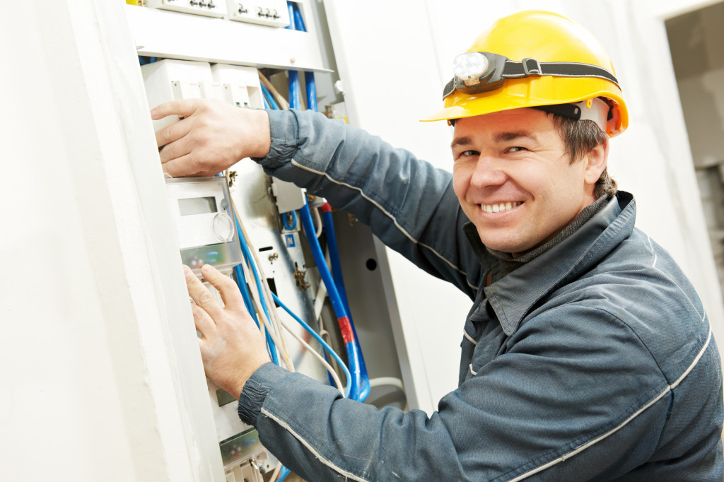 a man inspecting the electrical system of a house