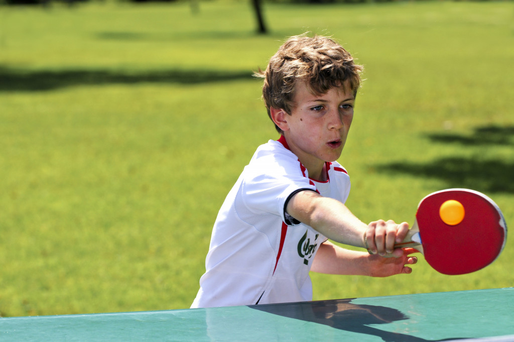 a kid playing table tennis