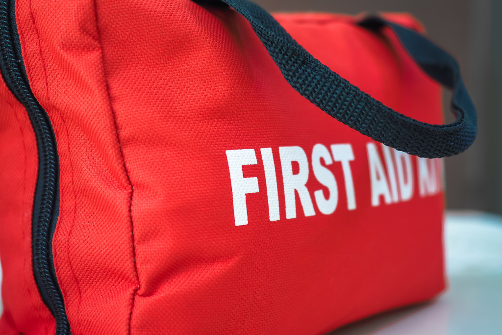 A red bag labeled with the words FIRST AID KIT