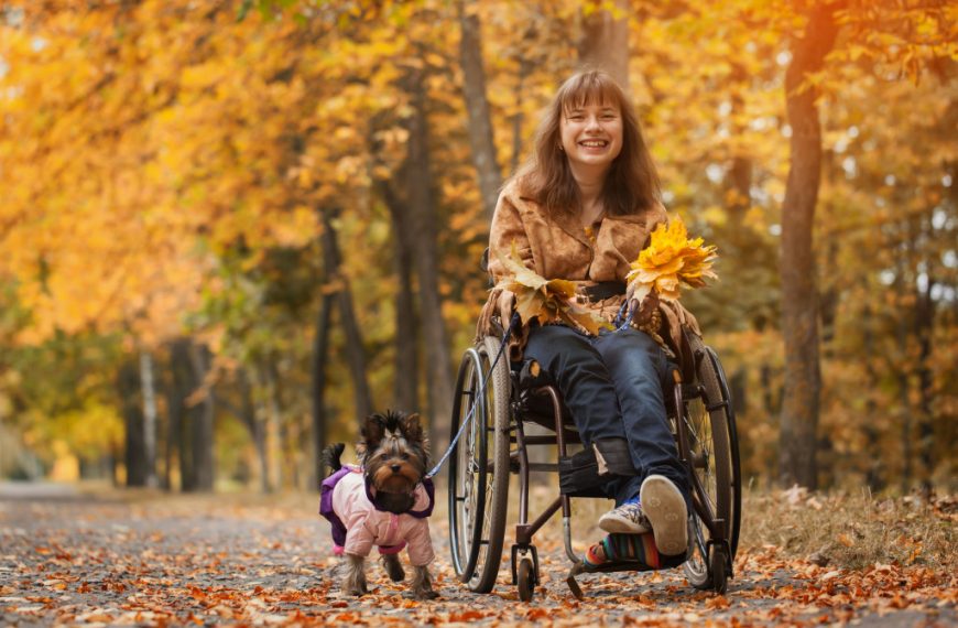 a woman in wheelchair with her dog