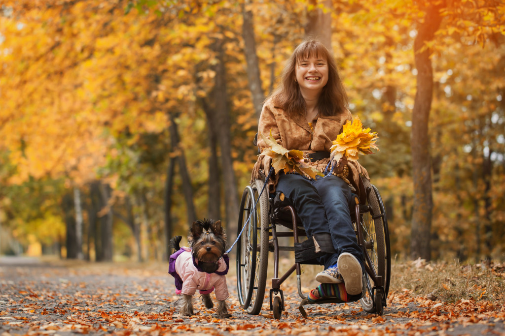 a woman in wheelchair with her dog